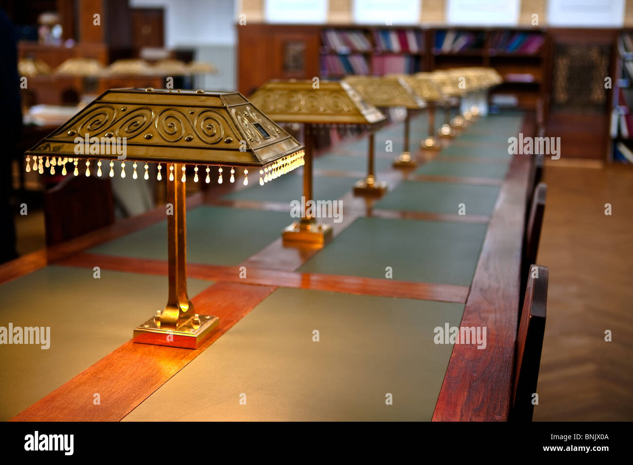 Big and old reading room shot with high depth of field DOF. Focus on the front lamp Stock Photo