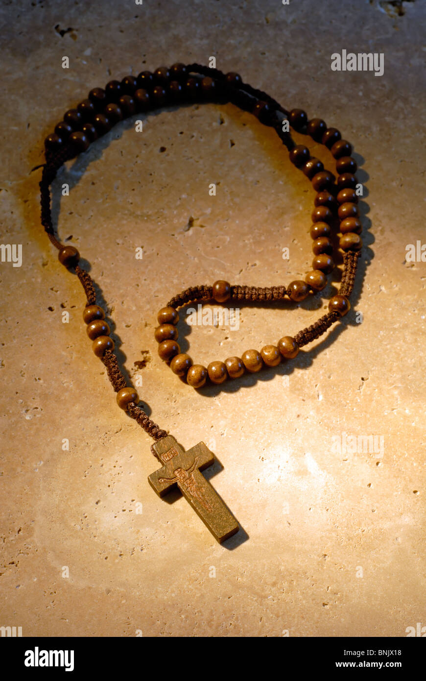 Wooden Rosaries Beads On A Stone Background In The Afternoon Sun Stock Photo
