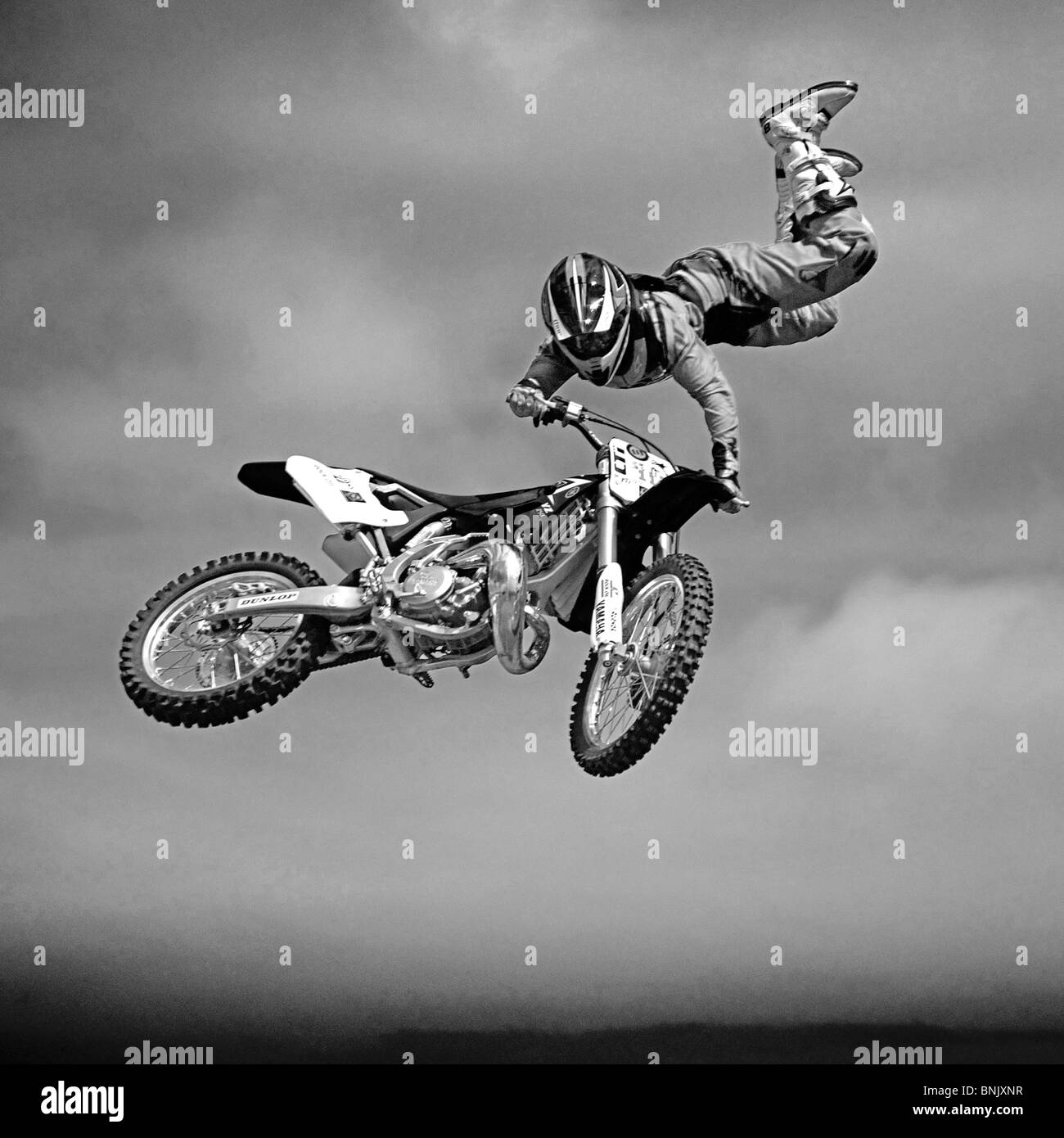 Freestyle motorcross jumper in black & white taken at the Goodwood Festival of speed as part of an acrobatic display Stock Photo