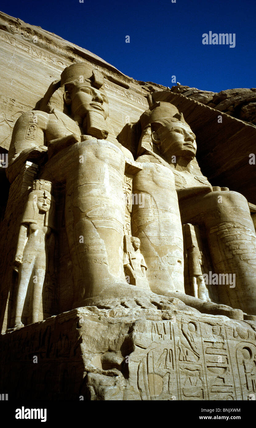 Two of the four colossi of Ramesses II at the Great Temple of Abu Simbel overlooking Lake Nasser in Upper Egypt. Stock Photo