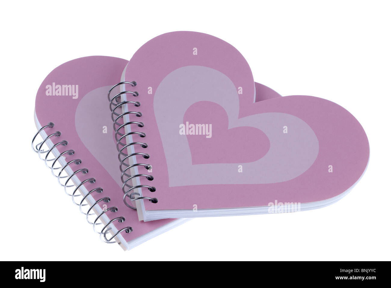 Two heart shaped metal ringbound pink notebooks Stock Photo