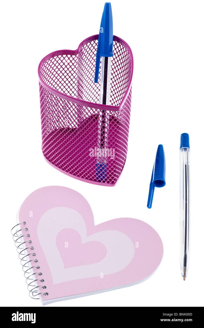 Heart shaped metal mesh pink pencil holder pen top and notebook Stock Photo