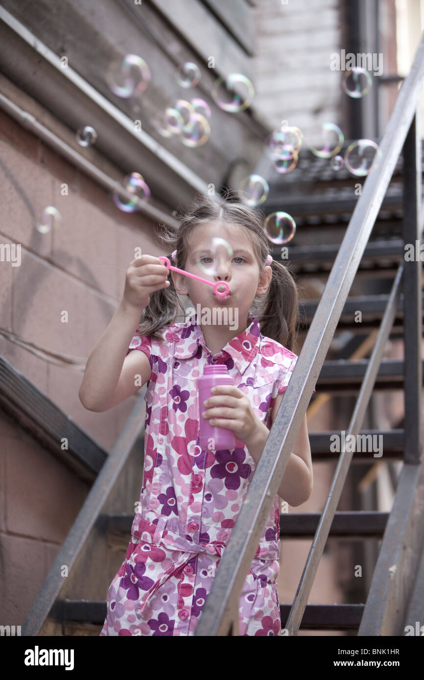 girl blowing  bubbles Stock Photo