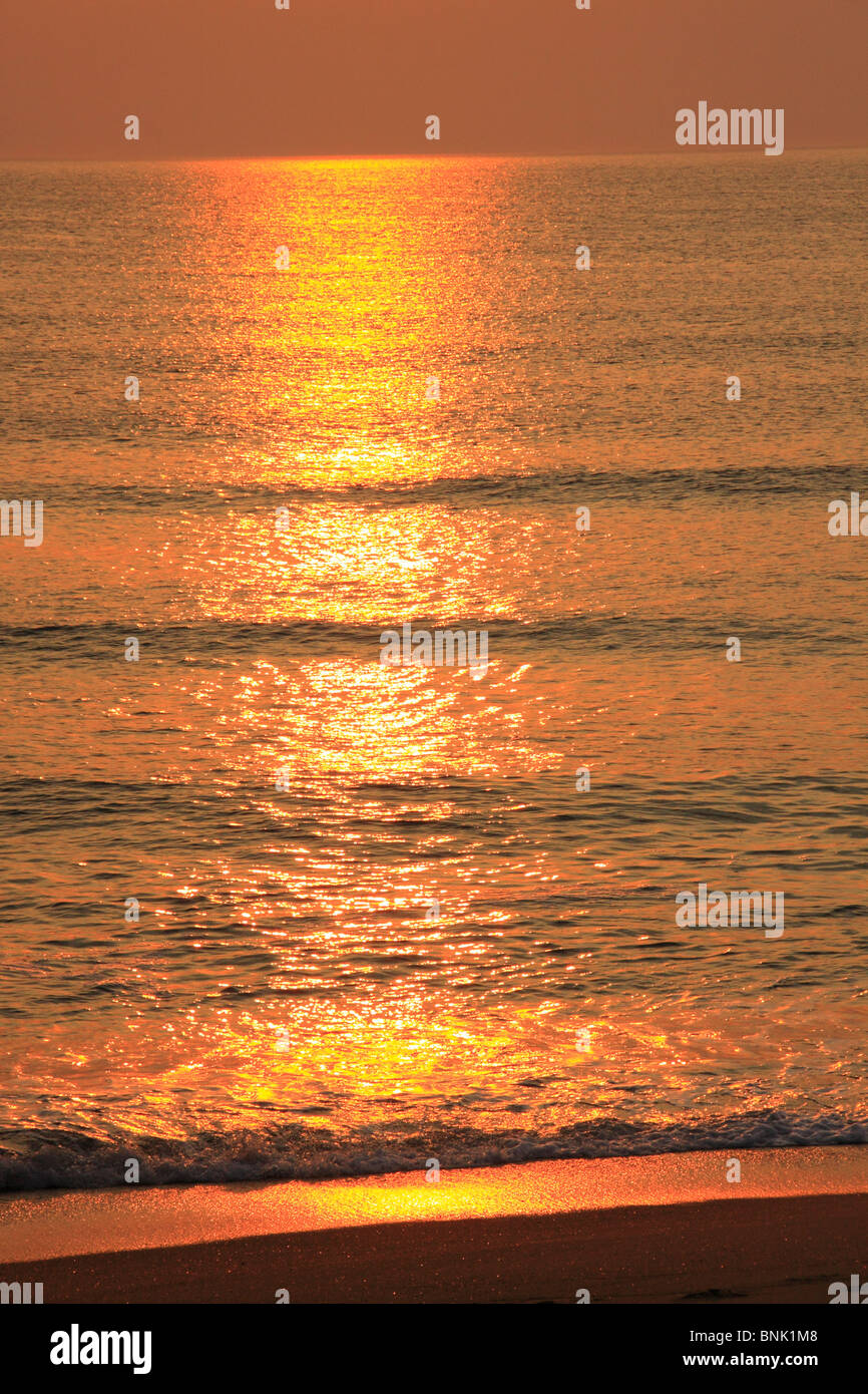 The Rising Sun Shimmers on the Water at Kitty Hawk Beach, North