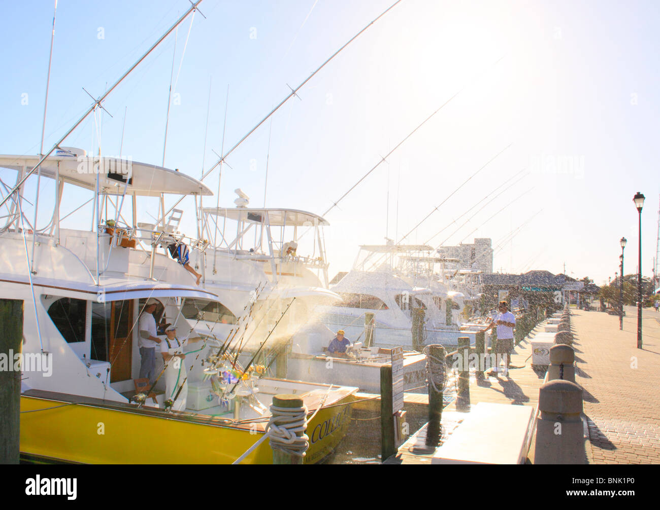 Washing down charter fishing boats at the end of the day at harbor in Morehead City, North