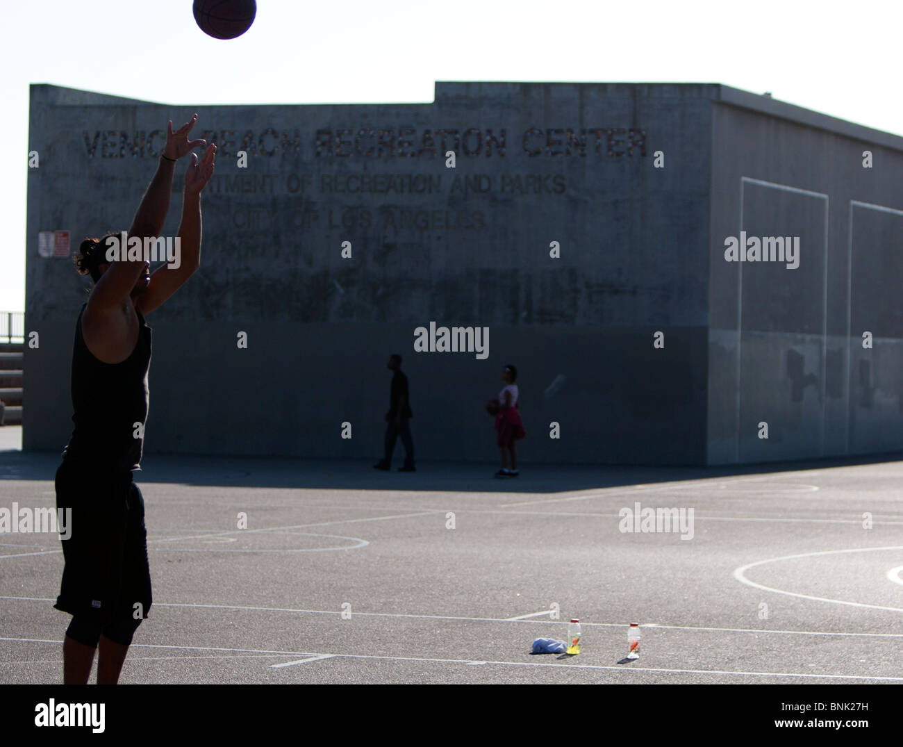 Guy shooting basketball at Venice Beach courts. Stock Photo