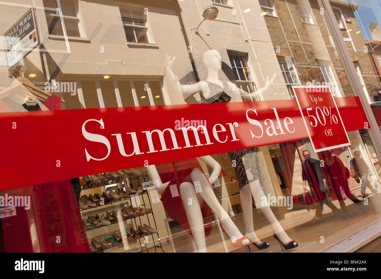 A Summer Sale Sign For Womens Clothes In A Shop Store Window In