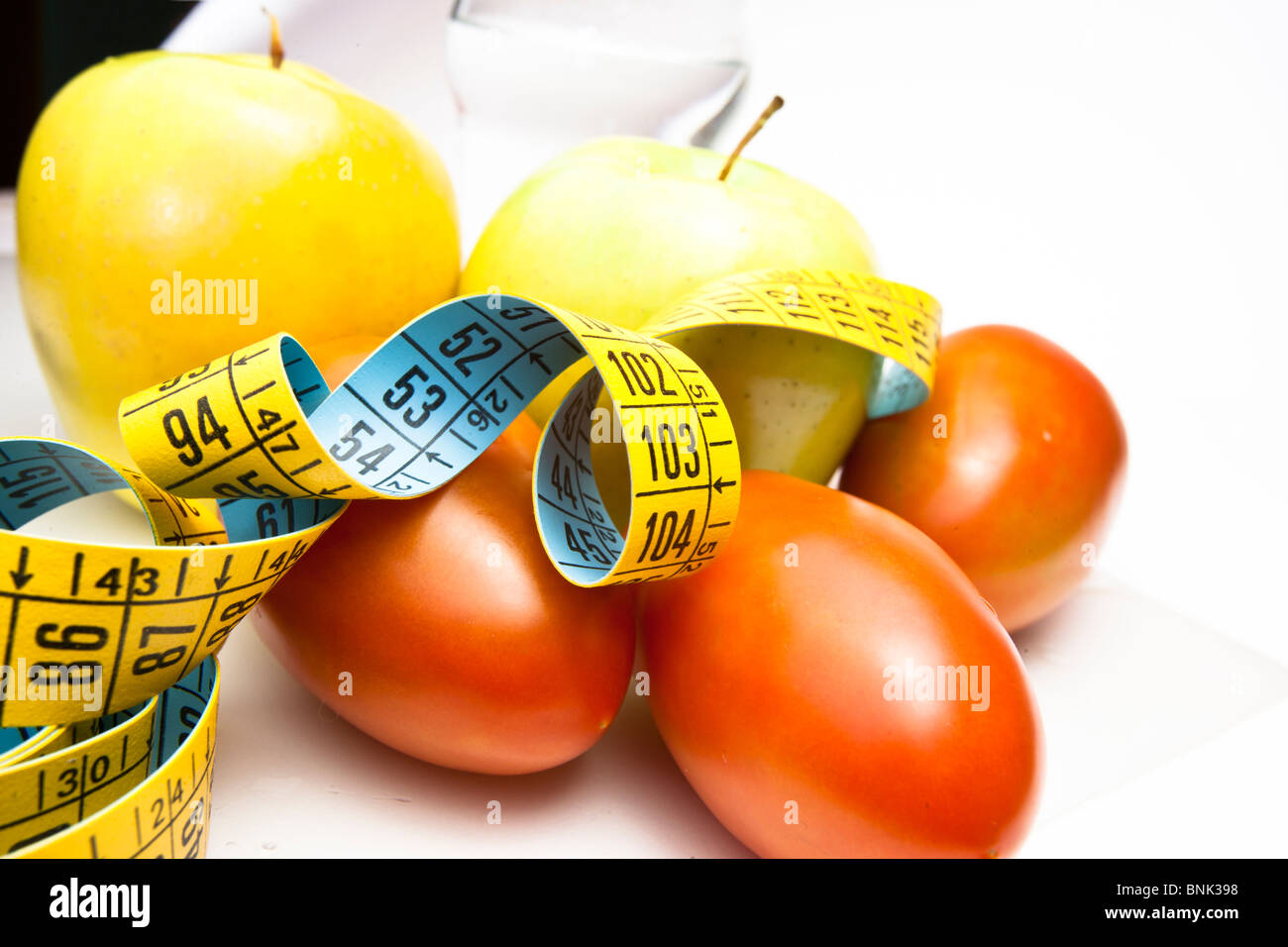 apples and tomatoes with centimeters Stock Photo