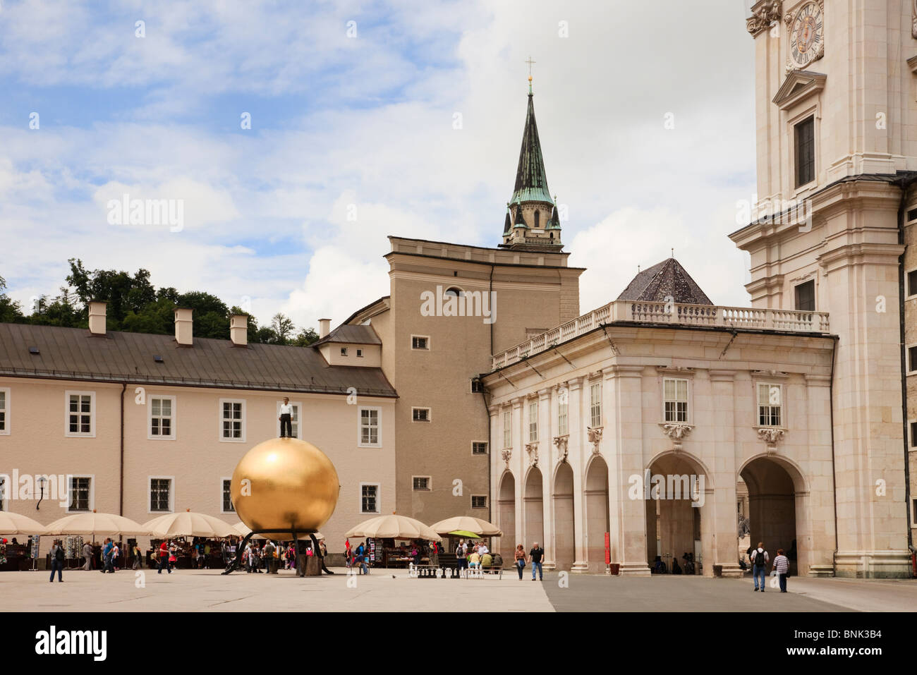 Kapitelplatz, Salzburg, Austria. St Peter's Abbey and 'Sphaera' sculpture in the historic city square by Dom Cathedral Stock Photo