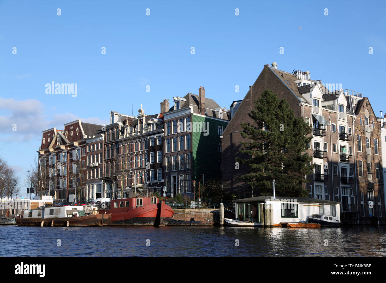 Canalside buildings seen from canal boat in Amsterdam Stock Photo