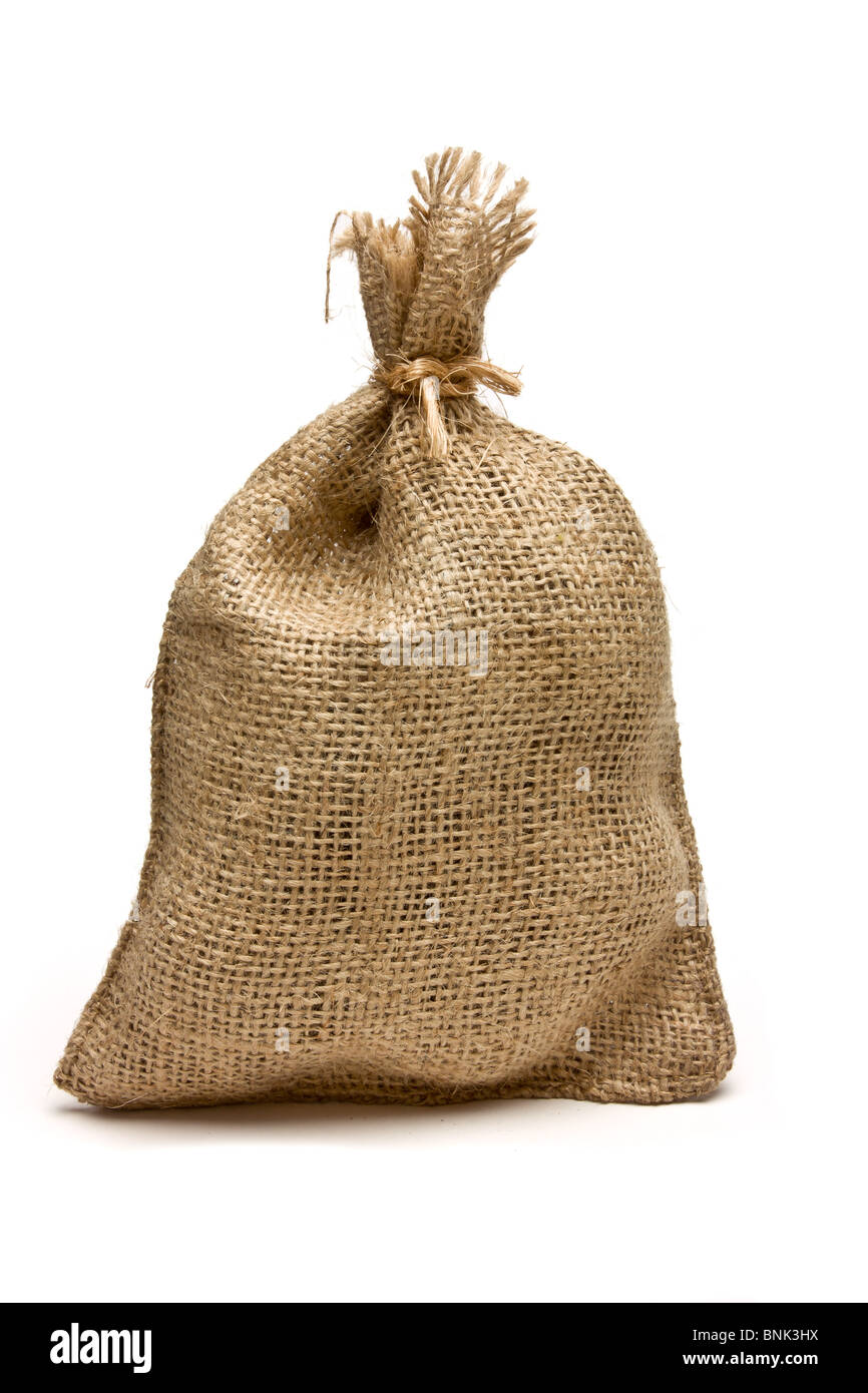 Hessian sack tied with string from low perspective isolated against white background. Stock Photo