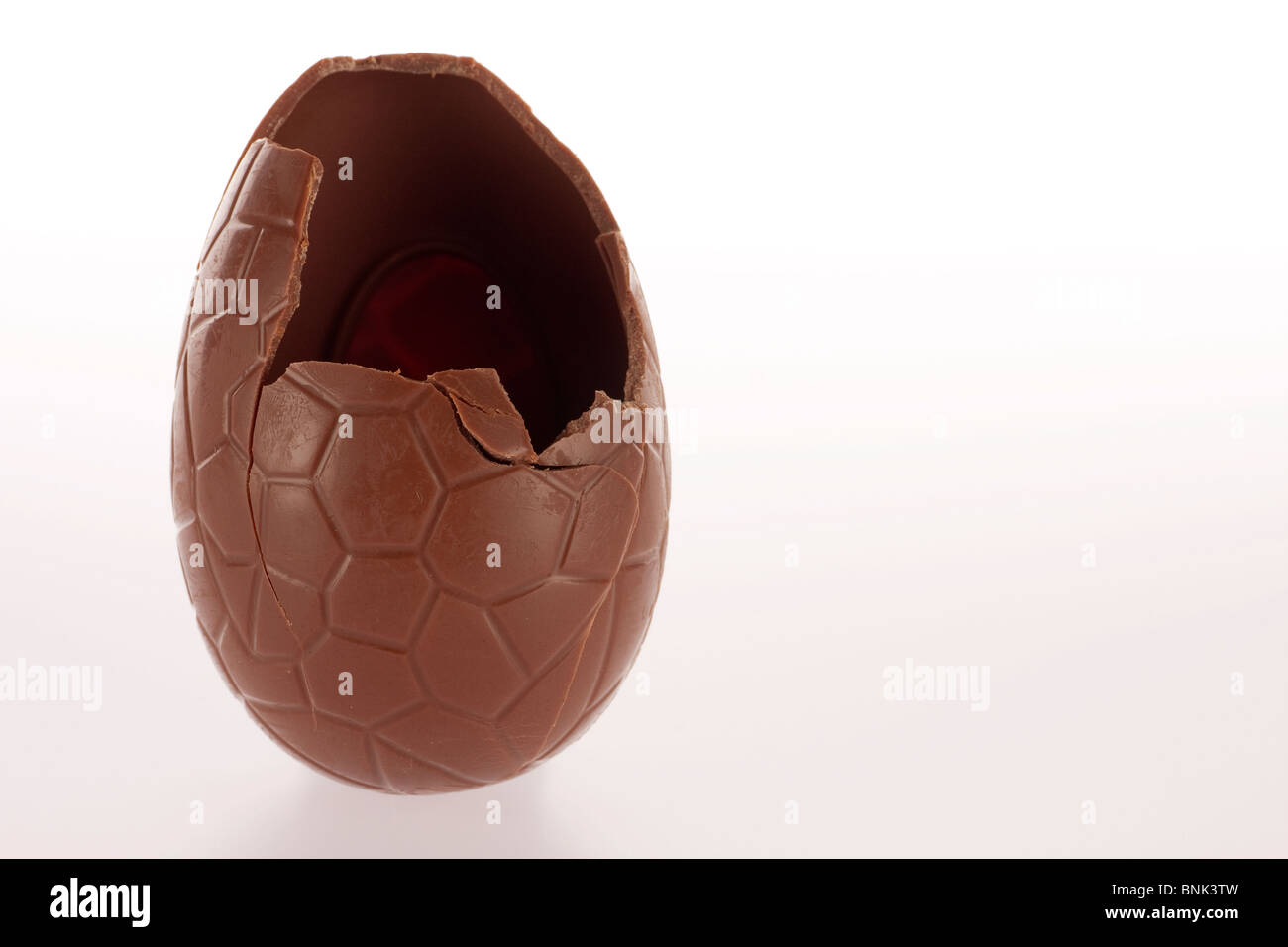 Chocolate easter egg with the top broken off Stock Photo - Alamy