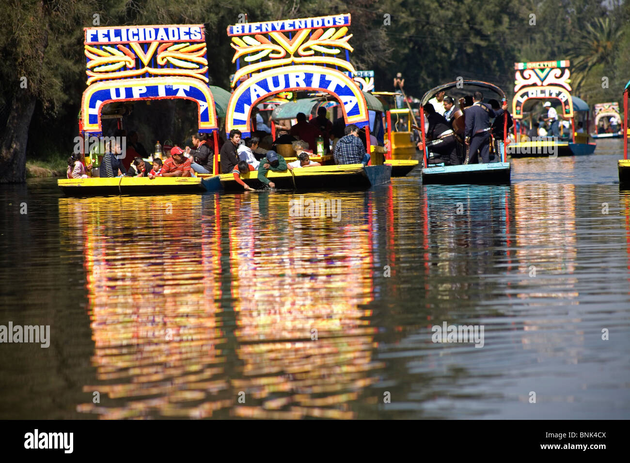 Tourists ride in boats through the water canals of Xochimilco on the
