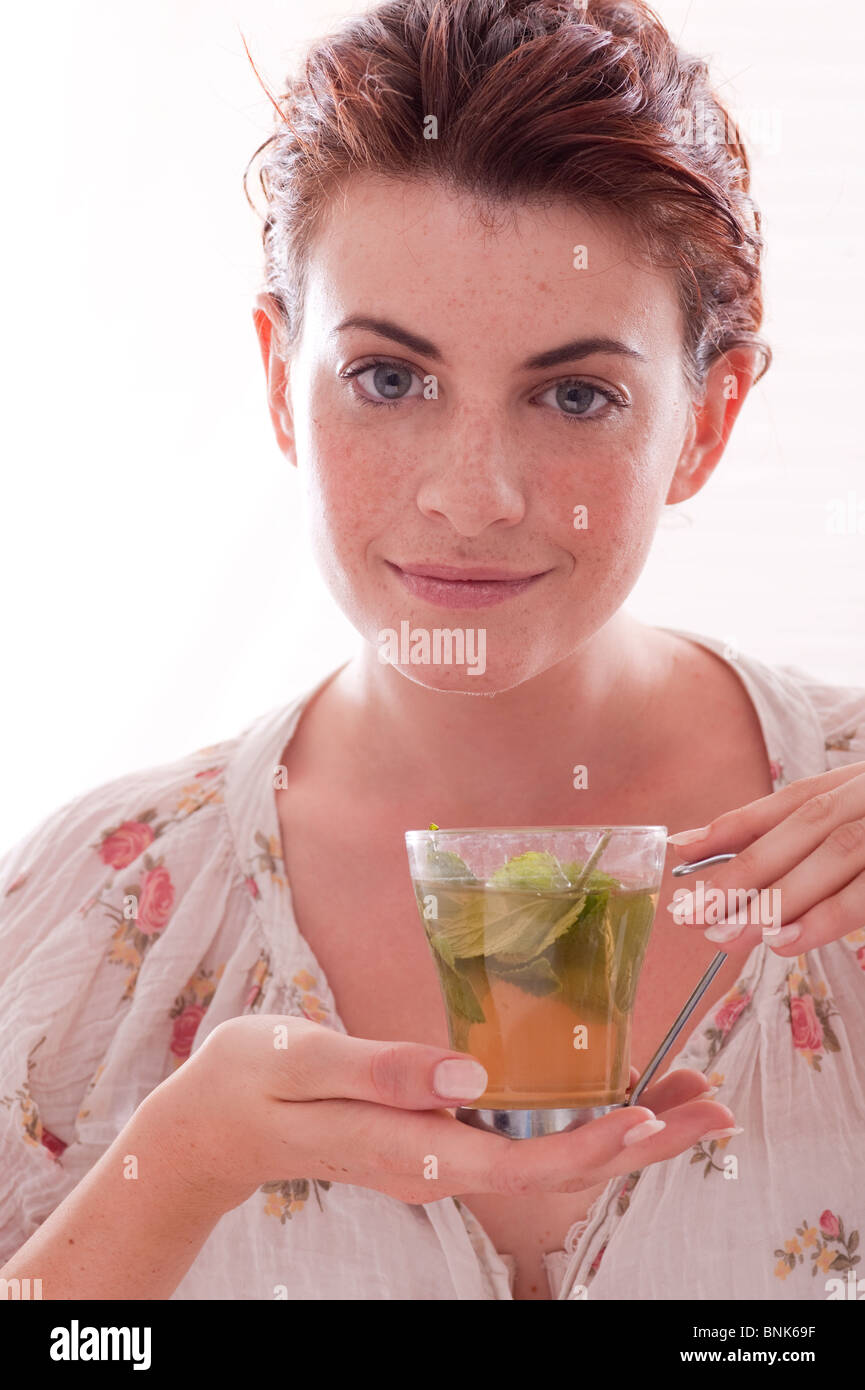 woman drinking green mint tea Stock Photo