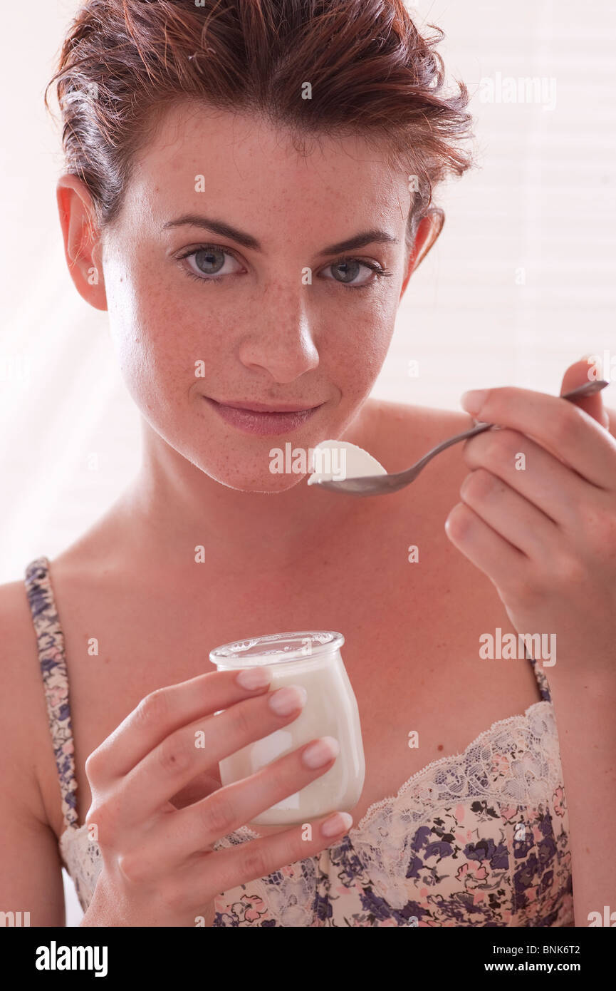 woman eating yogurt Stock Photo