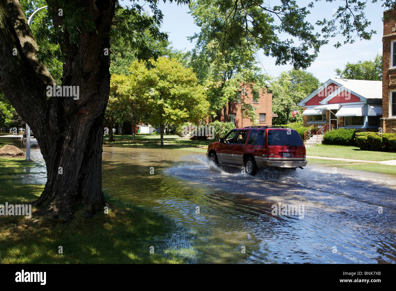 SUV driving through flooded street. Westchester, Illinois. Stock Photo