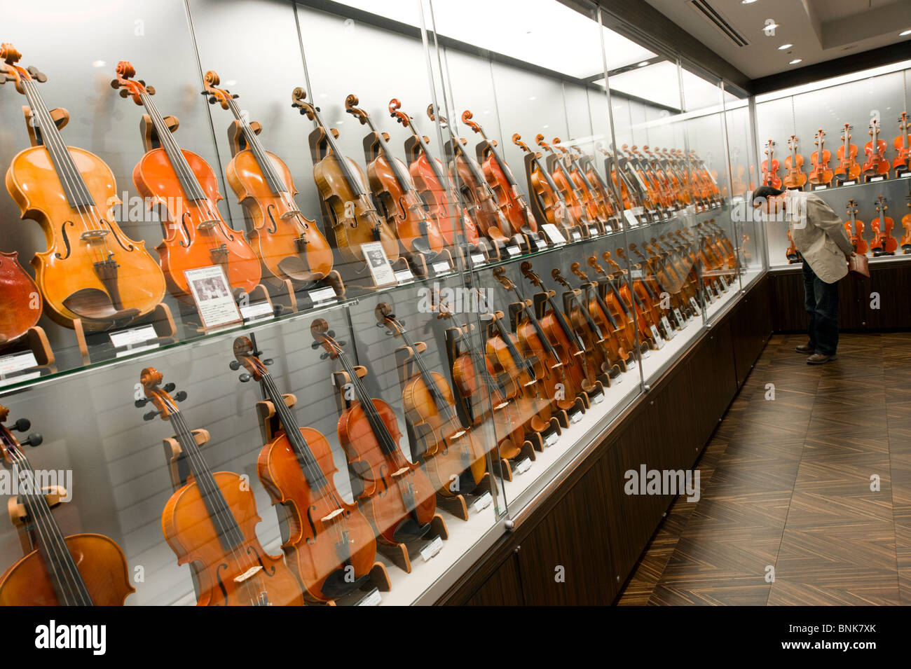 Violins in Yamaha Hall music shop in Chuo-dori, Ginza 4-chome, Tokyo, Japan Stock Photo