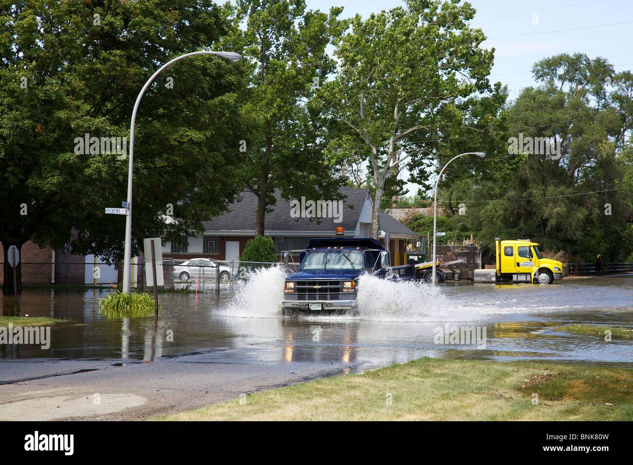 Water department truck driving through flooded street. Westchester, Illinois. Stock Photo