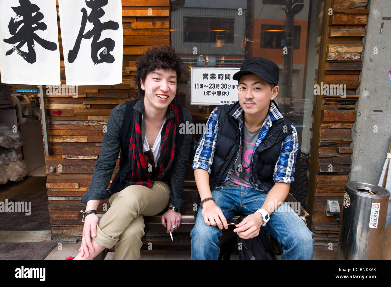 Trendy young people hanging out outside a bar in Shibuya, Tokyo, Japan Stock Photo
