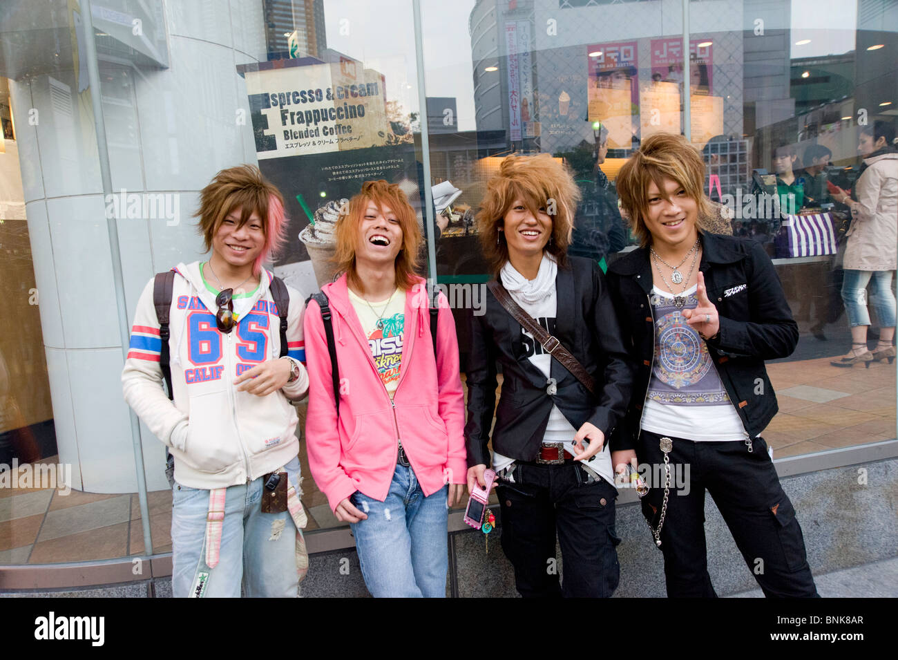 Trendy men with dyed orange hair hanging out in Shibuya, Tokyo, Japan Stock Photo