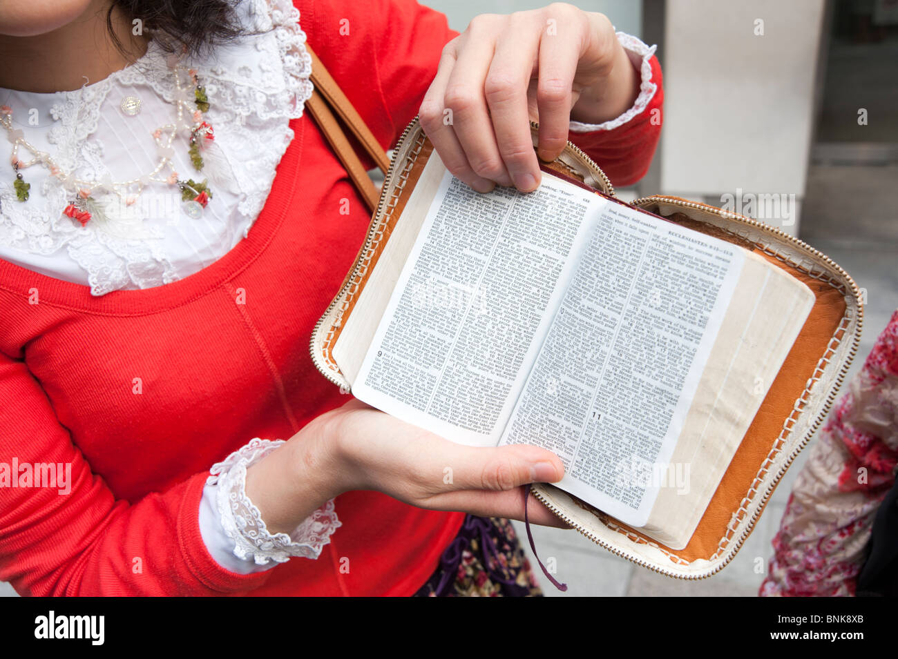 Jehovah's Witness showing passages from Ecclesiastes in the Bible, Tokyo, Japan Stock Photo