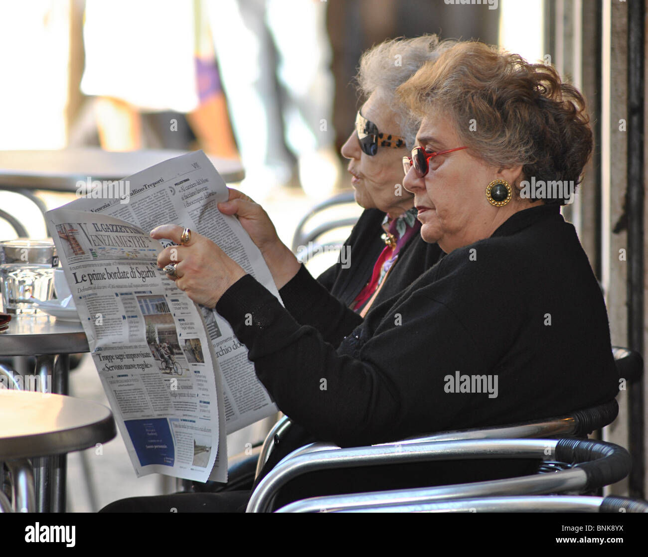 Old ladies reading newspapers, Venice, Italy Stock Photo