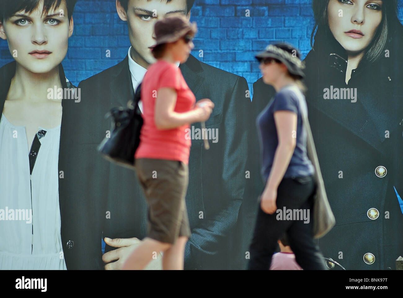 People walk past billboards advertising Burberry clothes, Venice, Italy Stock Photo