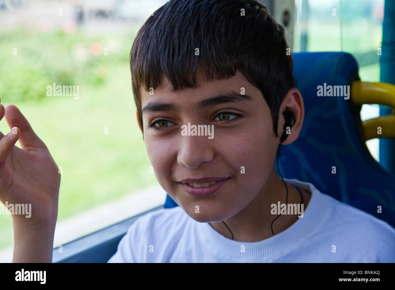 Azeri boy listening to headphones on a bus in Baku, Azerbaijan Stock Photo
