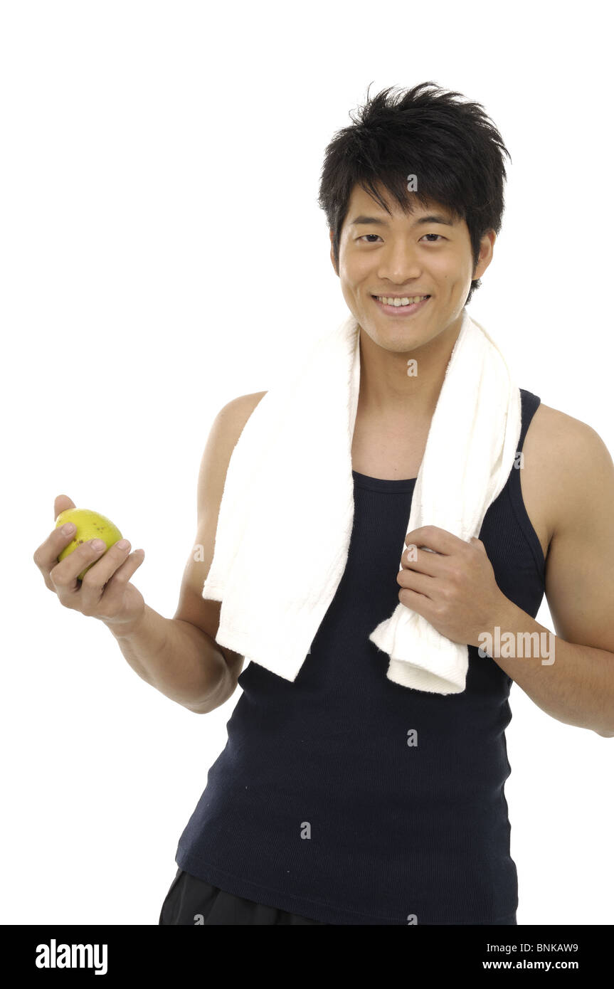 Portrait of a young man eating a lemon Stock Photo