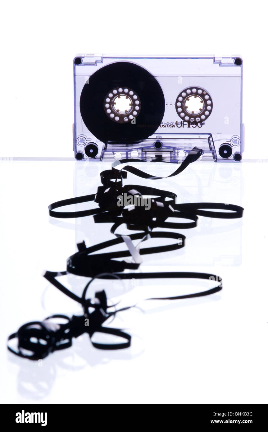 a cassette with tape spilling out white background Stock Photo