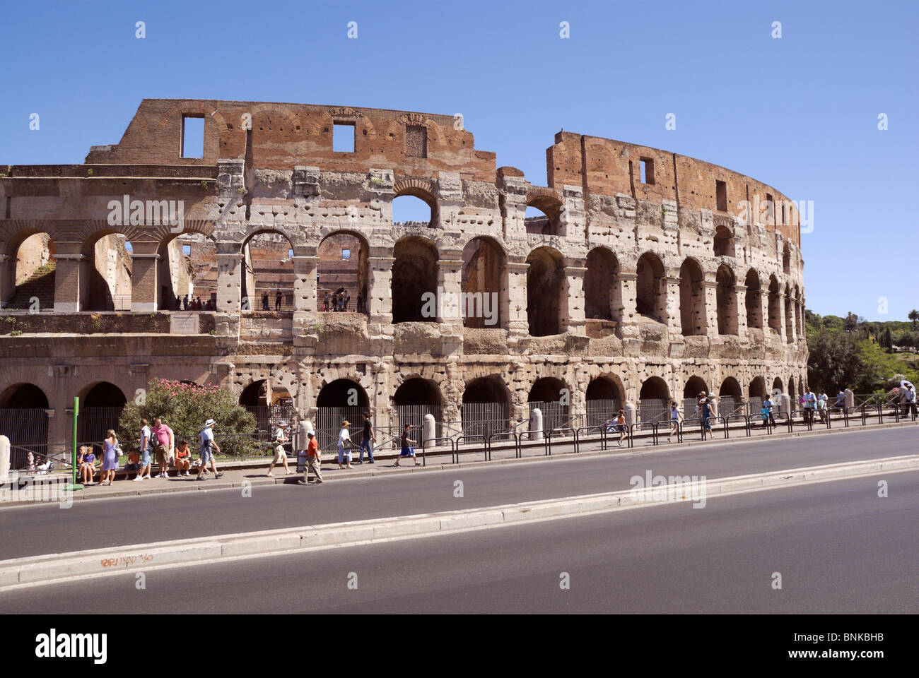 Rome, Italy, Coliseum partial view with passing tourists Stock Photo