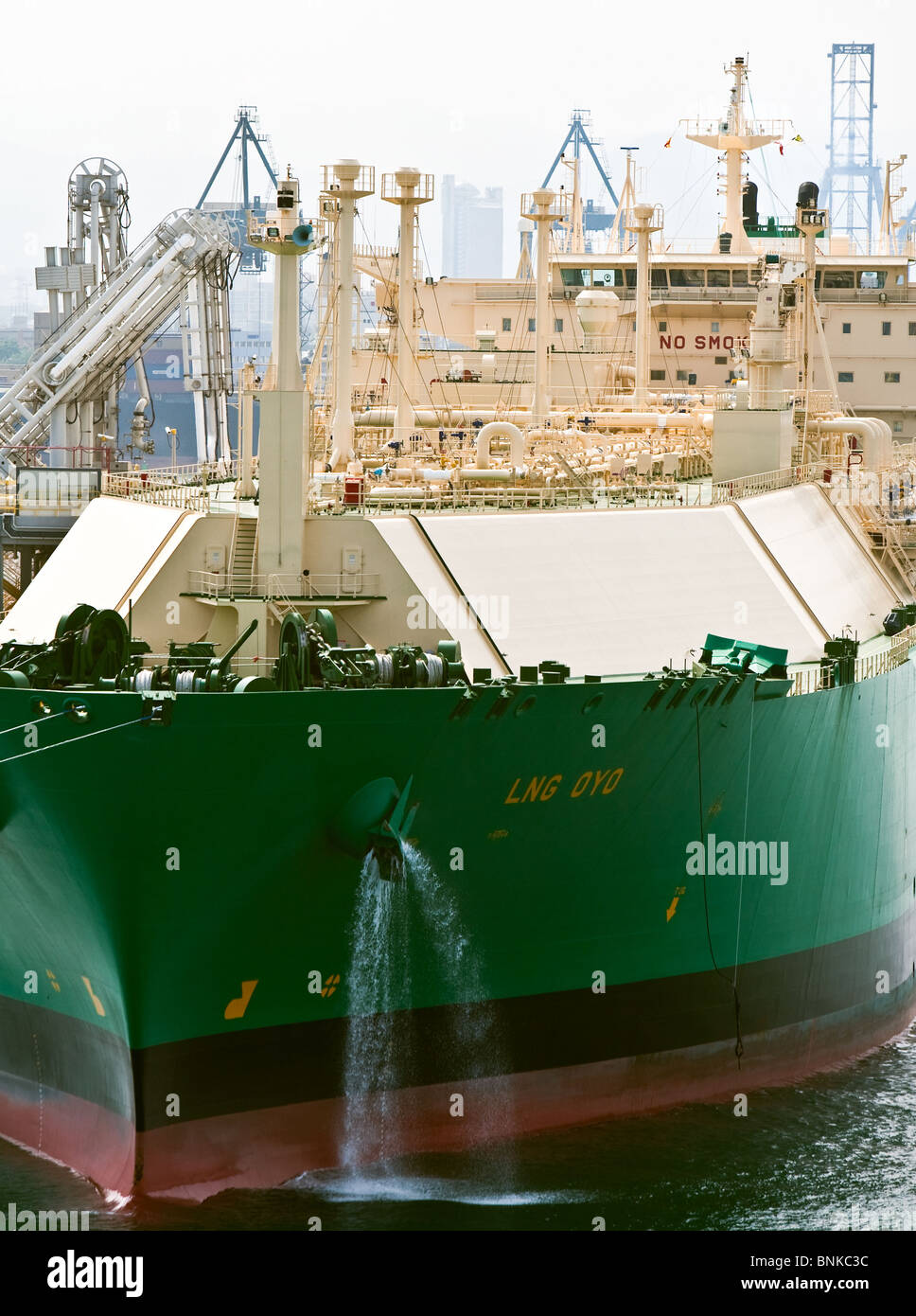 lng tanker oyo discharging liquefied natural gas cargo at Barcelona terminal Stock Photo