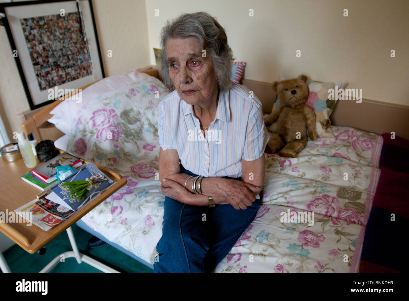 Sad elderly woman in care home Stock Photo