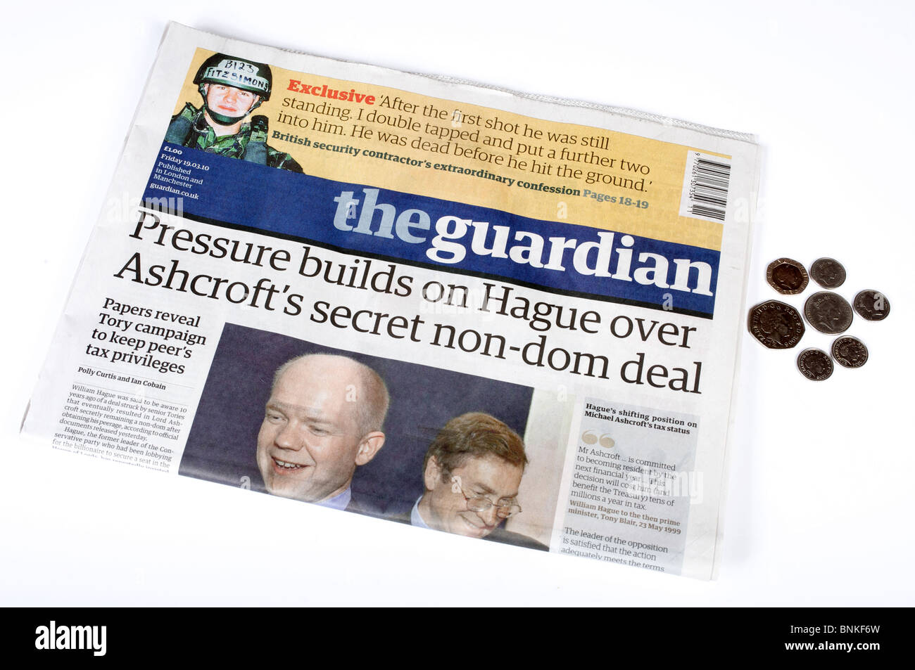 Copy of The Guardian newspaper with the cover price of one pound shown in coins Stock Photo