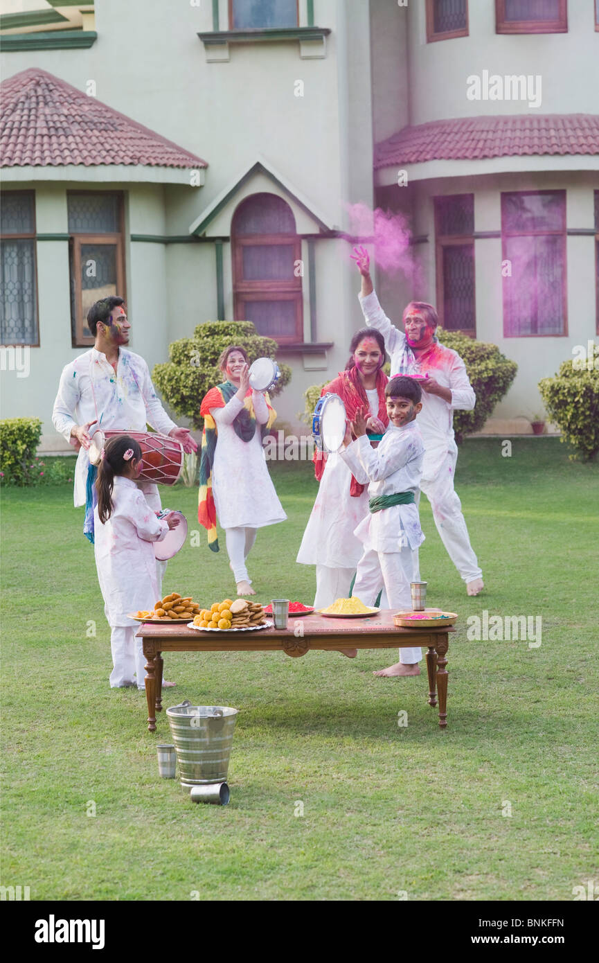 Family celebrating Holi Stock Photo