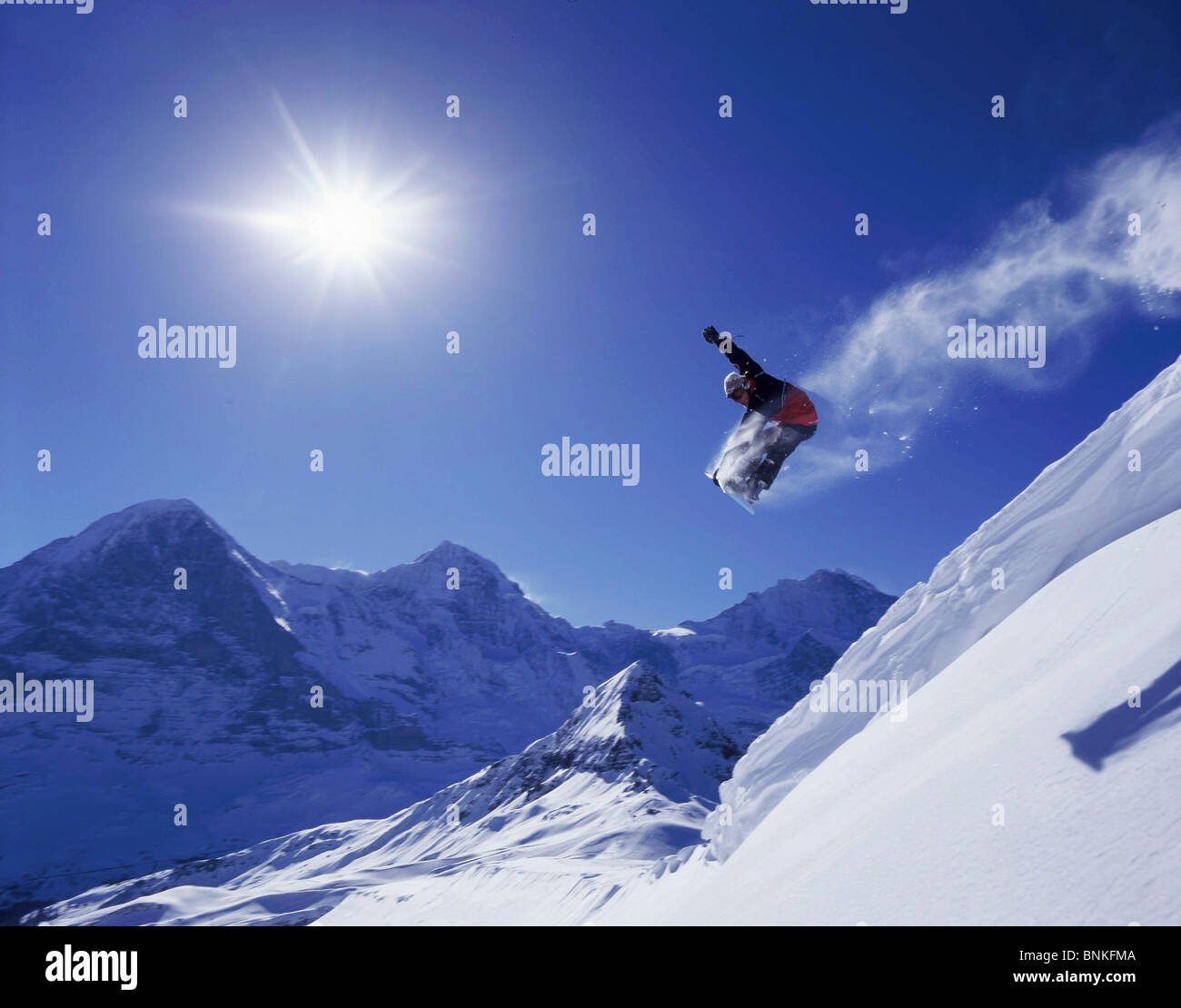 Switzerland winter sports snowboard freeride man jump Snow boarder sun back  light sport spare time adventure Jungfrau monk Stock Photo - Alamy