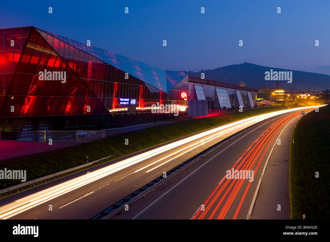 Bulle Switzerland canton Freiburg dusk twilight house home factory glass facade highway cars