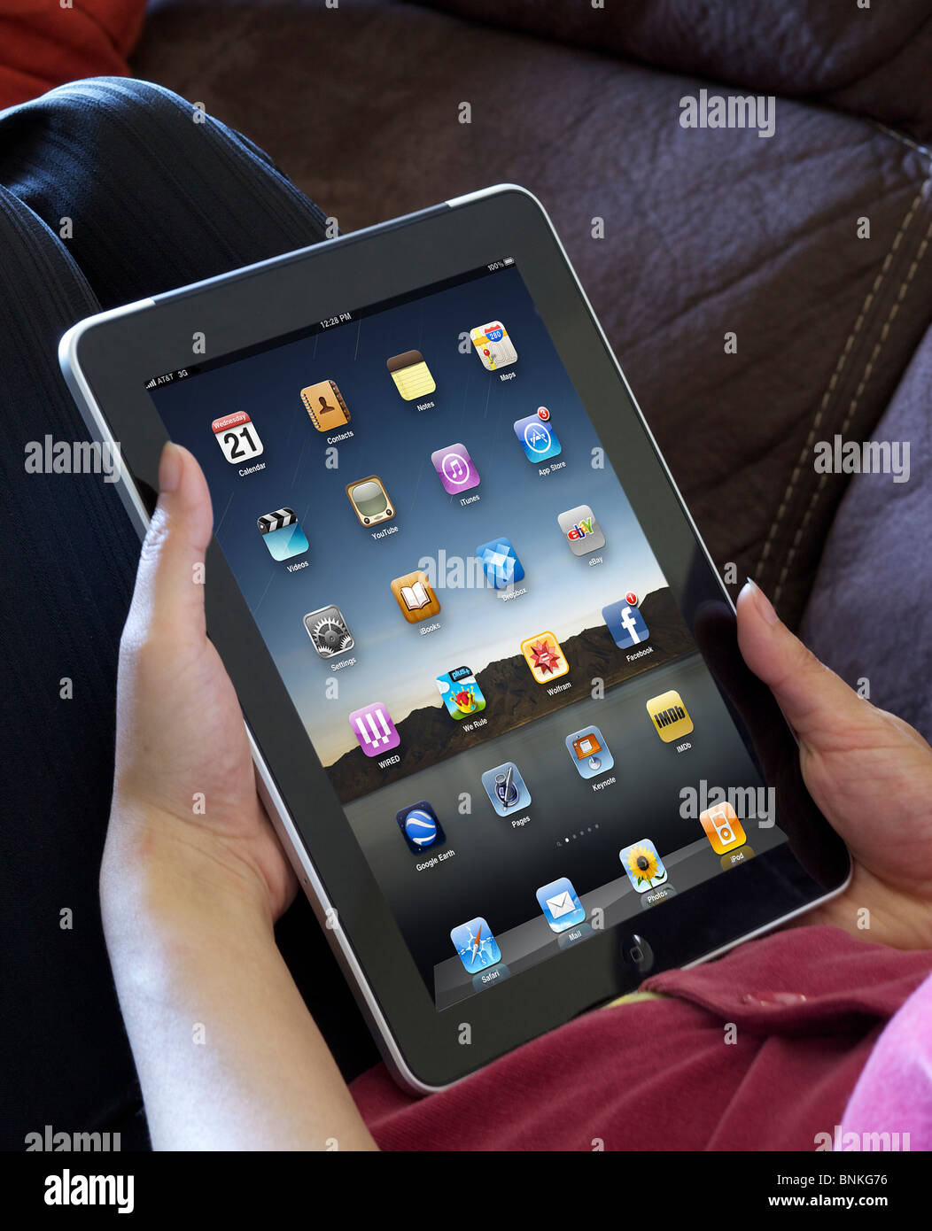 A closeup picture of a woman relaxing while showing her iPad
