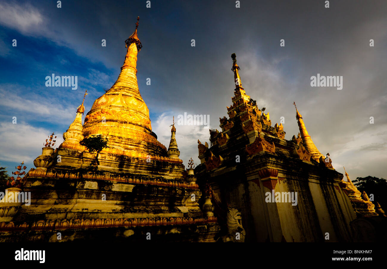 Golden Pagodas in dramatic light near Inwa (Awa) , Myanmar Stock Photo