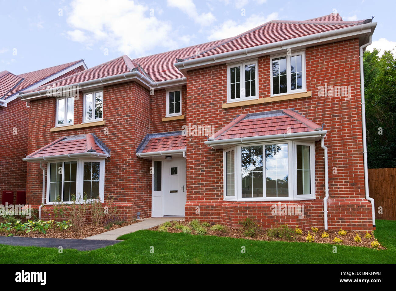 Photo of a brand new unoccupied detached red brick built five bedroom house on a modern housing development. Stock Photo