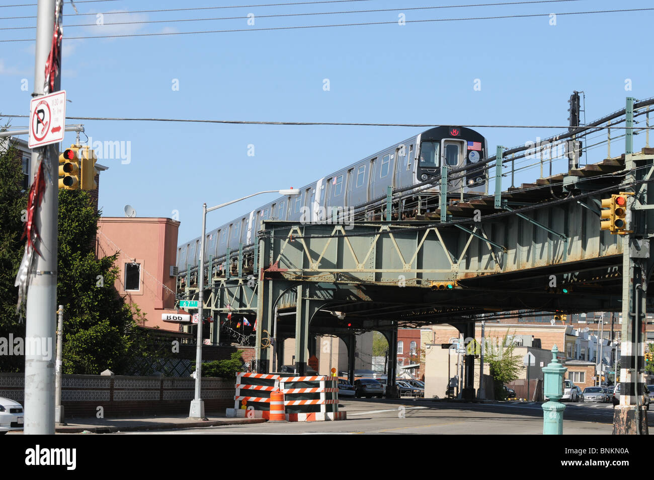 elevated subway train traveling over a street in Brooklyn New York USA Stock Photo
