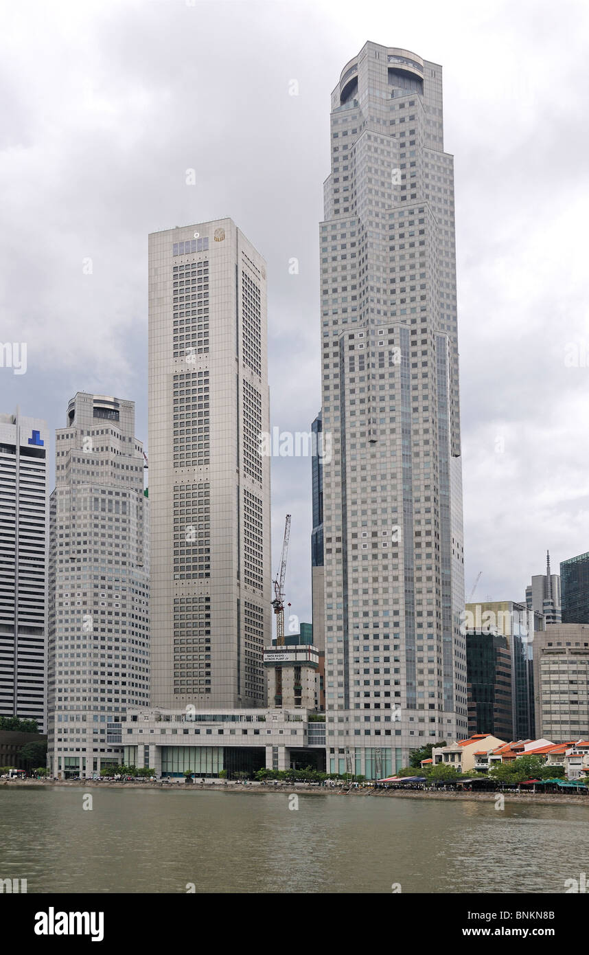 Skyline of Singapore with traditional small houses with tall sky scrapers Stock Photo
