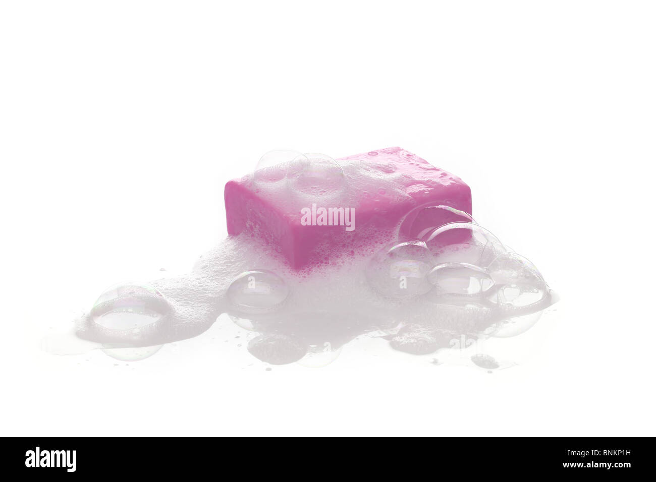 A bar of pink soap with soap bubble isolated on white background Stock ...
