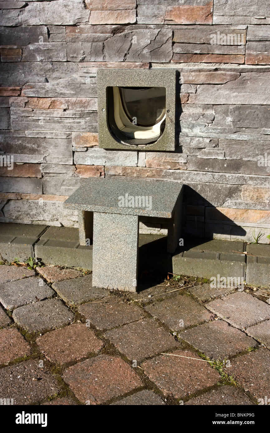 cat flap in brick wall