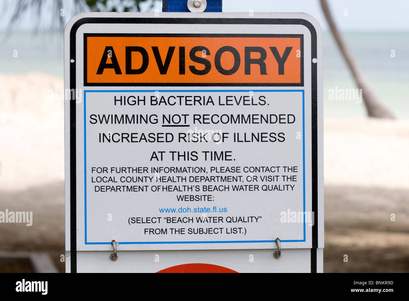 Health advisory warning sign, Florida Keys beach Stock Photo