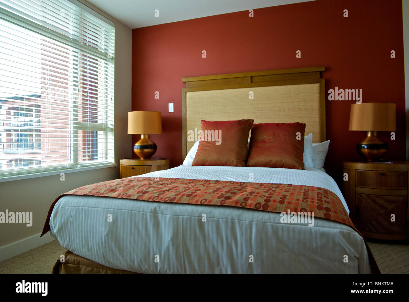 Natural light guest bedroom display double bed with decorative throw