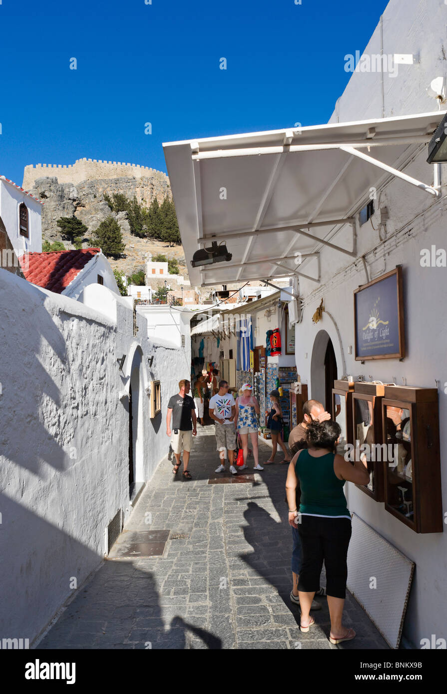Shops in the village centre of Lindos with the Acropolis on the hilltop