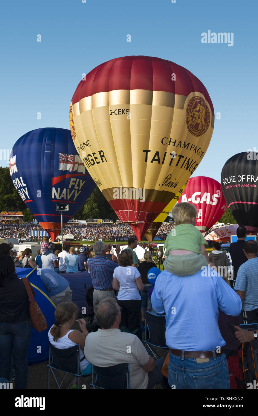 Hot air balloons being prepped for a mass ascent and crowds watching at the Bristol Balloon fiesta. Stock Photo