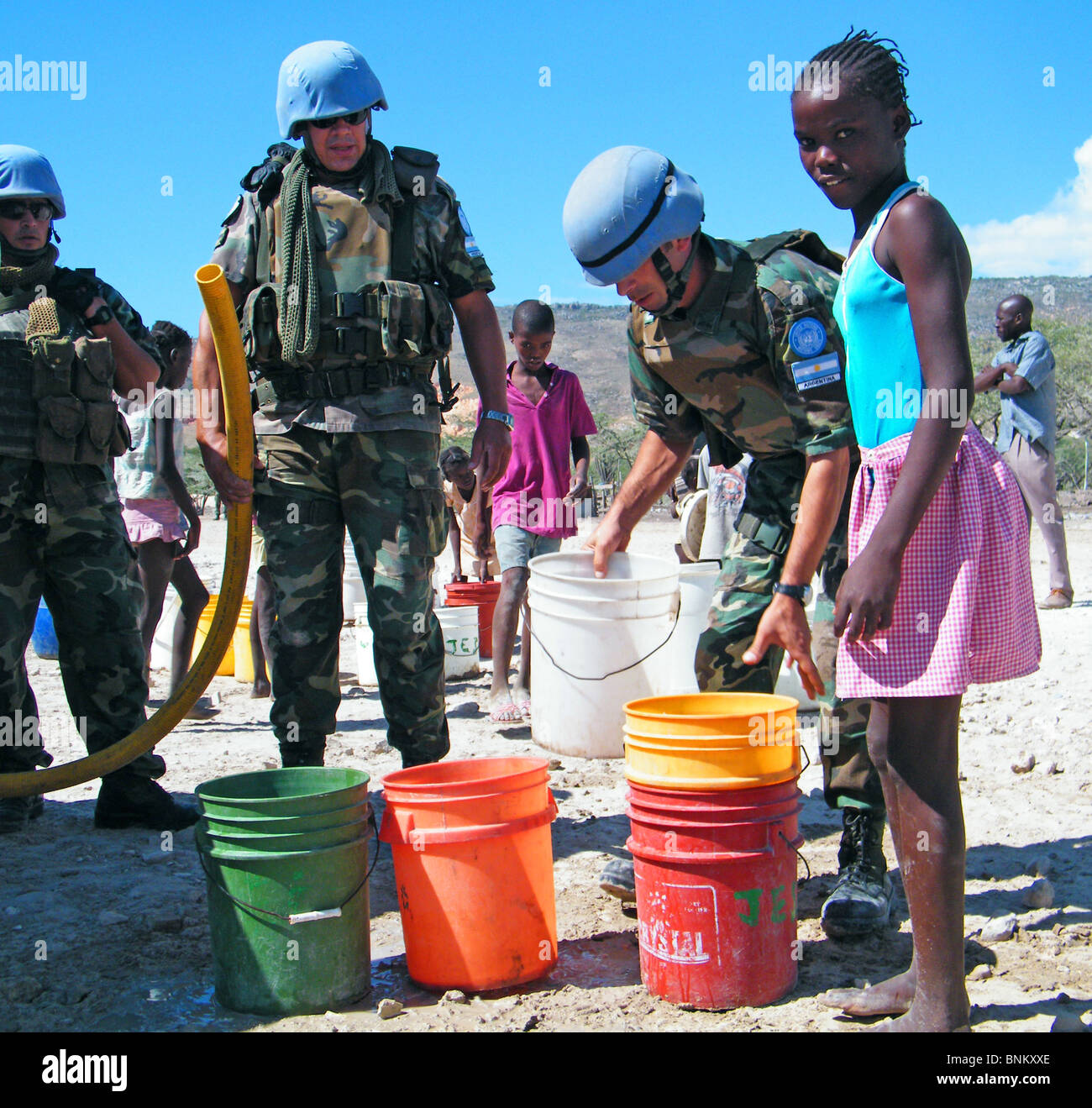 A girl waits for drinking water distributed by the United Nations outside Gonaives, Haiti Stock Photo