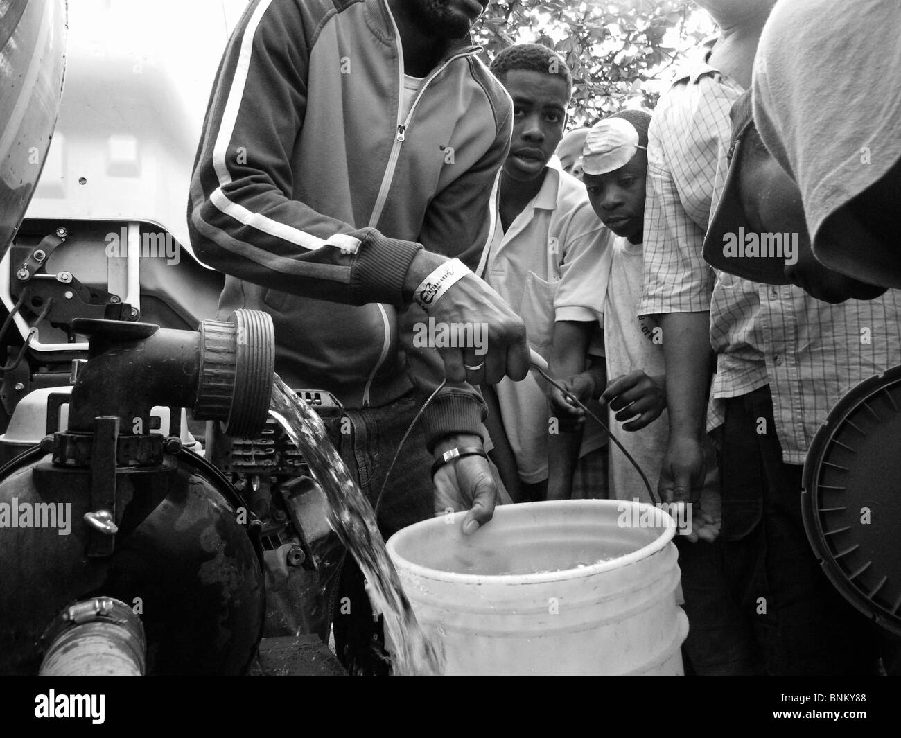 Water bucket queue Black and White Stock Photos & Images Alamy